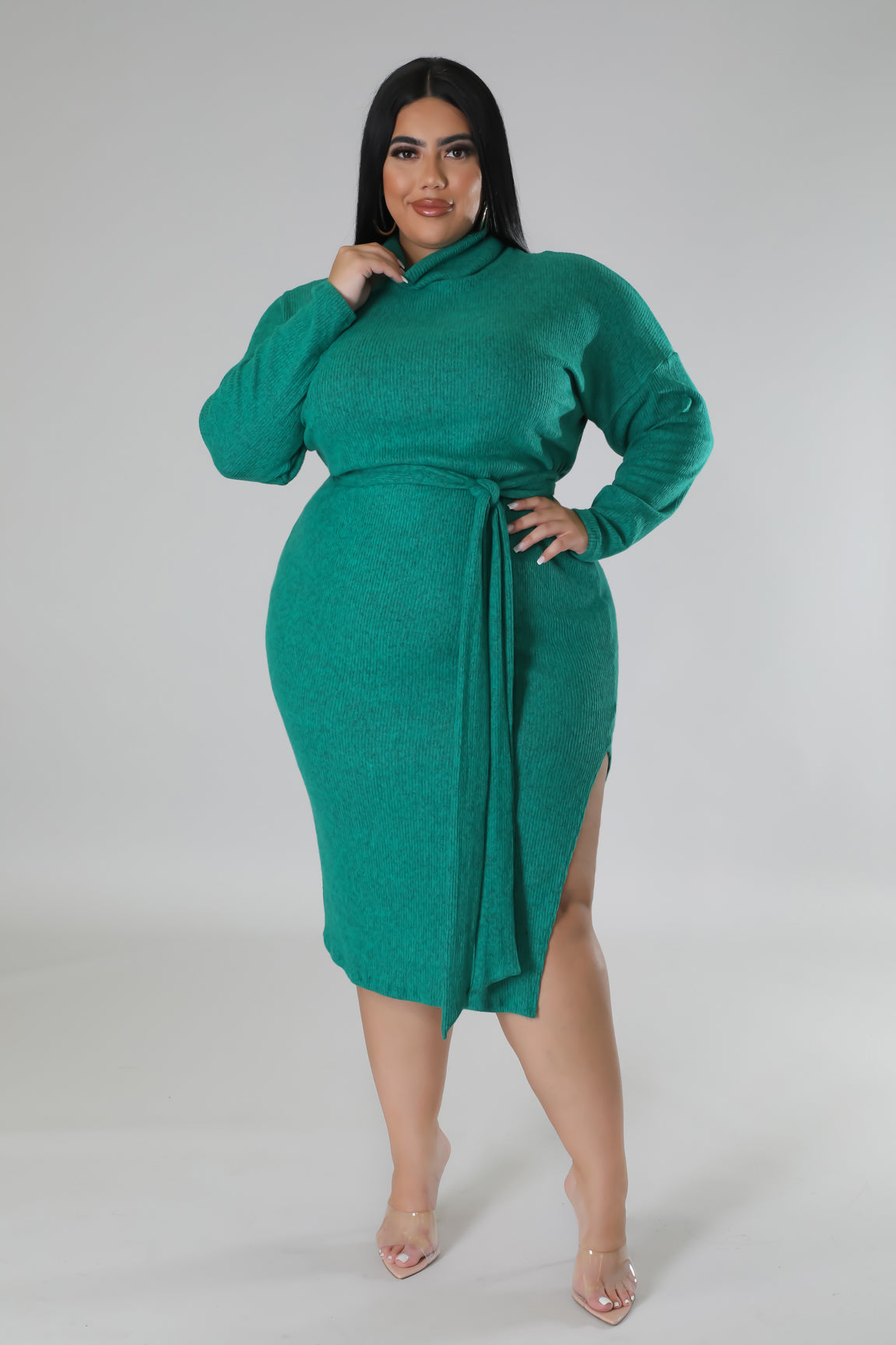 Front view of model wearing cozy knit turtle neck dress with slit