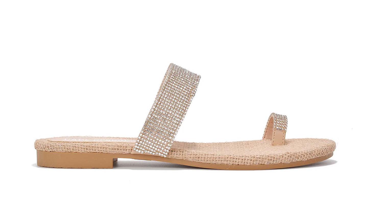 A flat tan sandal with silver sparkling gems along straps and toe ring strap.